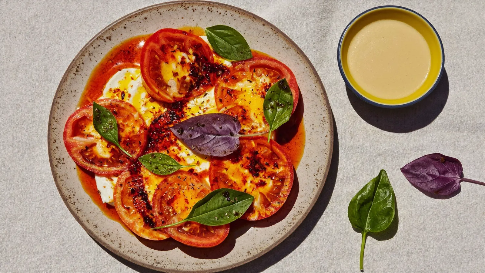 A vibrant overhead food spread with fresh herbs and chili oil.